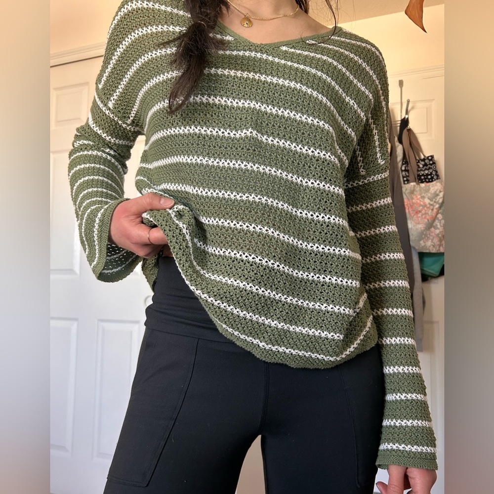 Green and white striped crochet sweater.